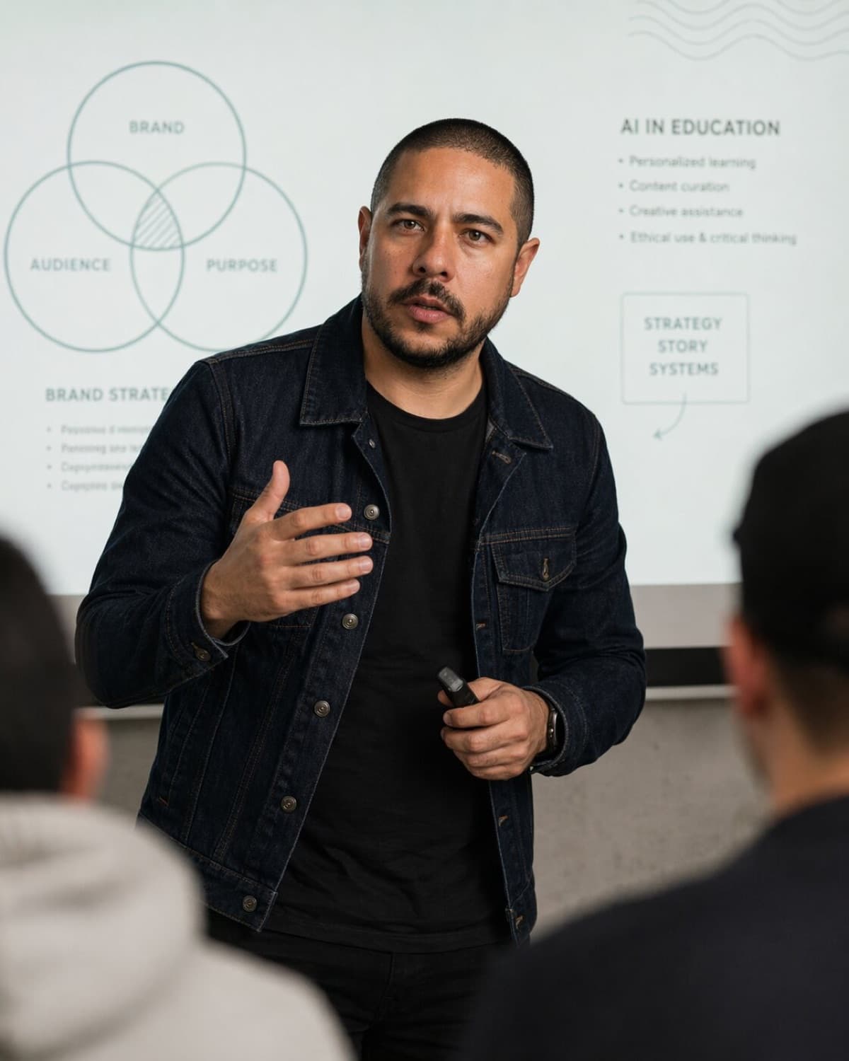 Luis Miguel mid-gesture, teaching a class on AI in education in front of the projected slides
